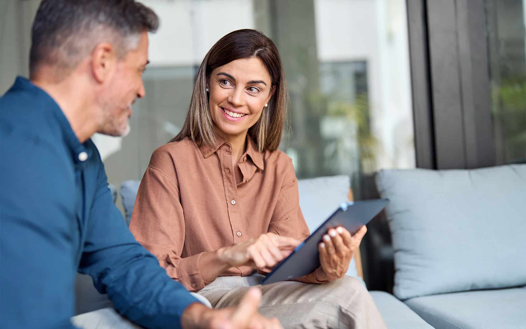 Woman Showing A Client Information From A Tablet